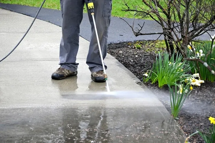 Professional pressure washing a concrete sidewalk in San Diego by SeaBreeze Home Service
