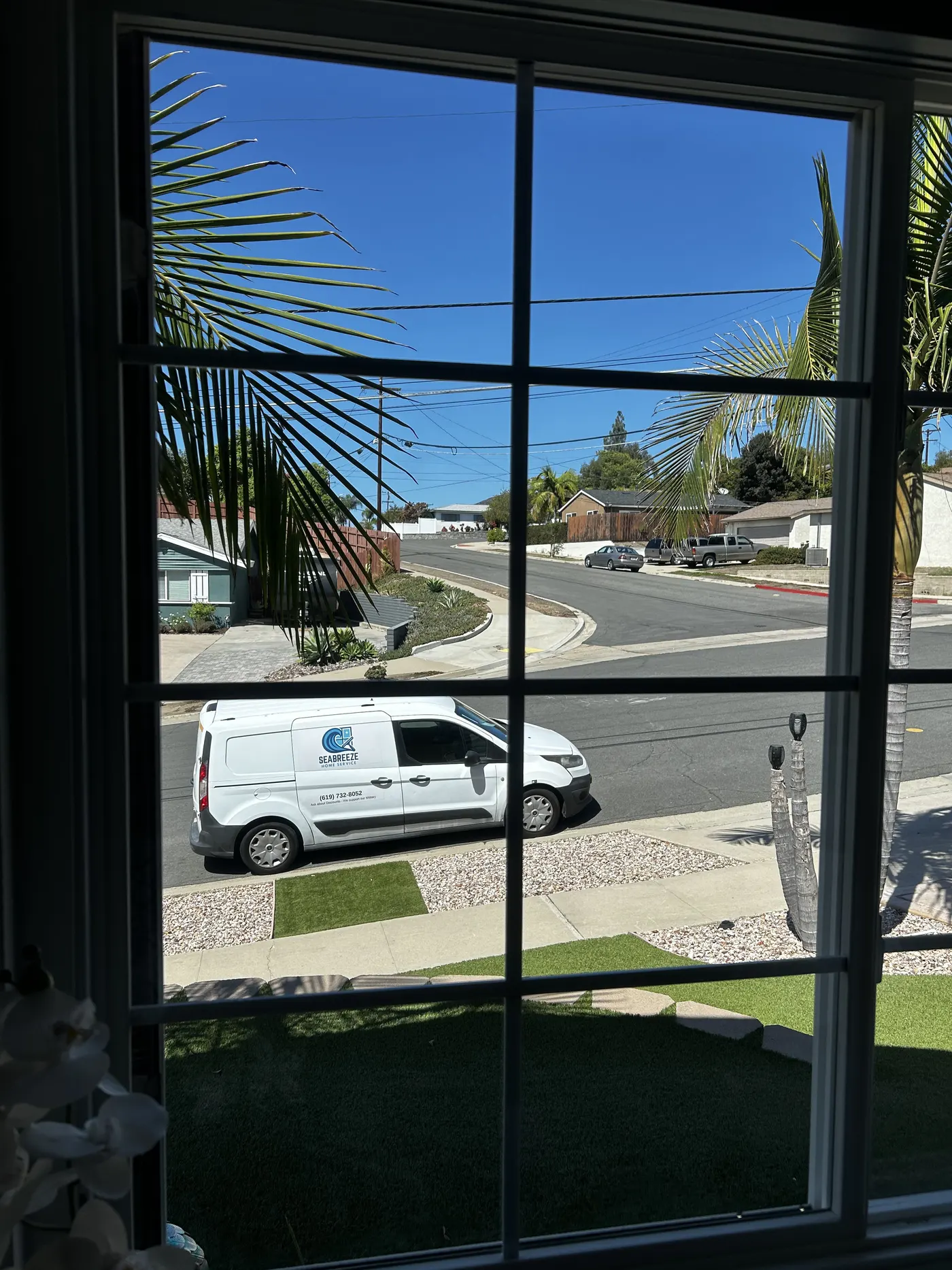 SeaBreeze Home Service van seen through a freshly cleaned window in San Diego