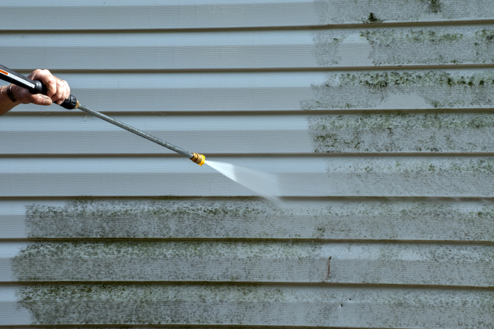 Soft washing house siding in San Diego with low-pressure spray by SeaBreeze Home Service