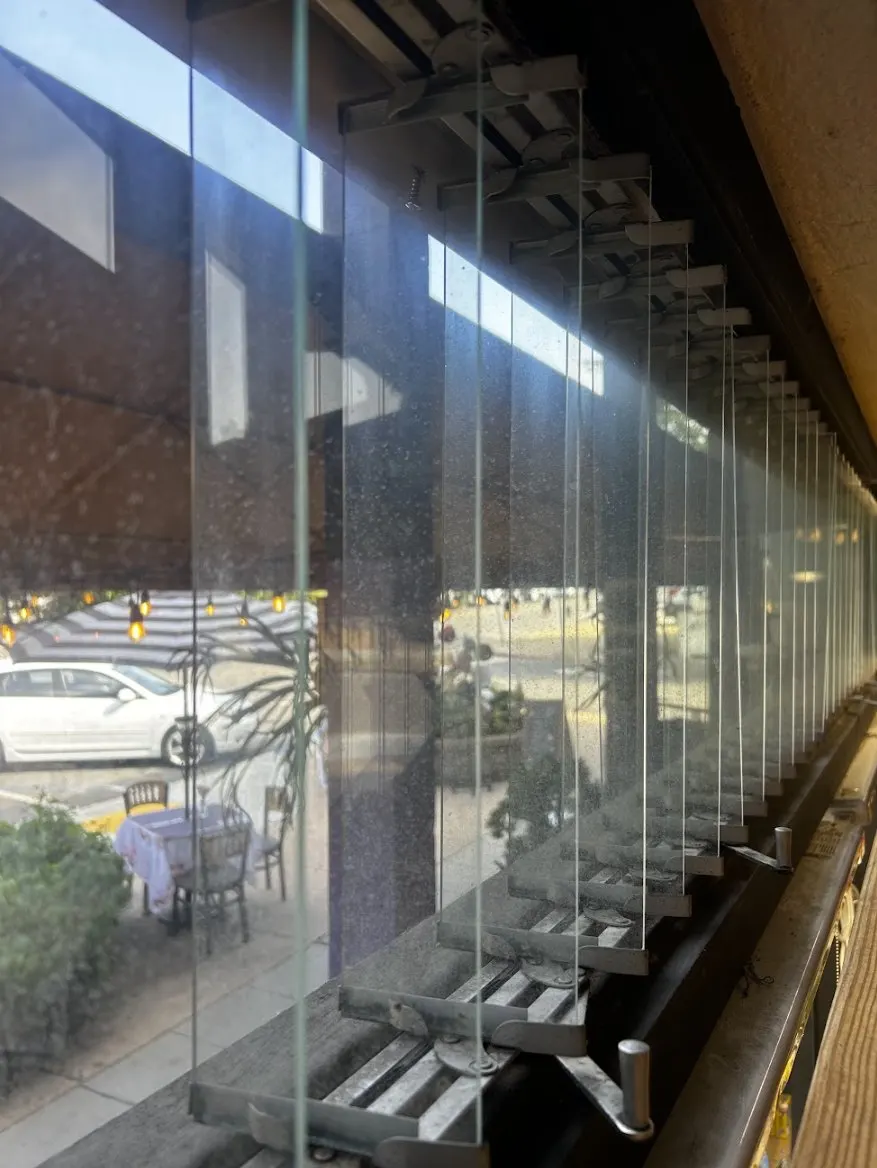 Dirty commercial windows before professional cleaning by SeaBreeze Home Service in San Diego